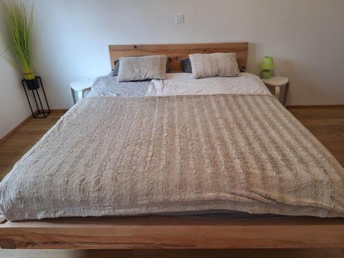 a bedroom with a large bed with a brown comforter at Apartma San Izola - near the beach San Simon in Izola