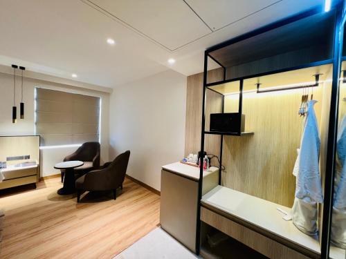 an office with a desk and a chair and a room at Hyphen Business Hotel in Noida