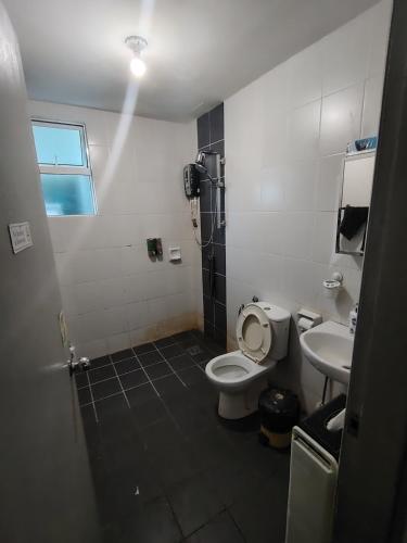 a bathroom with a toilet and a sink at Private Room in Condominium - Sandakan Friend House in Sandakan