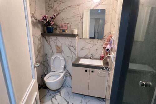 a bathroom with a toilet and a sink at BlancHaus Stays - Premium Luxury I Viman Nagar I Near Pune Airport I Skyline View in Pune