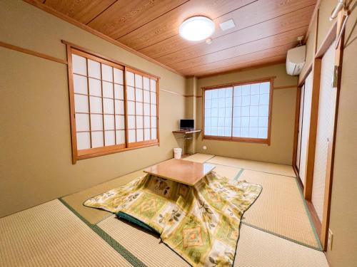 a room with a table in the middle of a room at Chouchinya in Nozawa Onsen