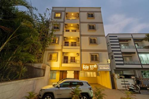 a white suv parked in front of a building at Itsy Hotels Lotus Executive in Pune