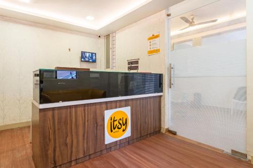 a waiting room with a large flat screen tv at Itsy Hotels Lotus Executive in Pune