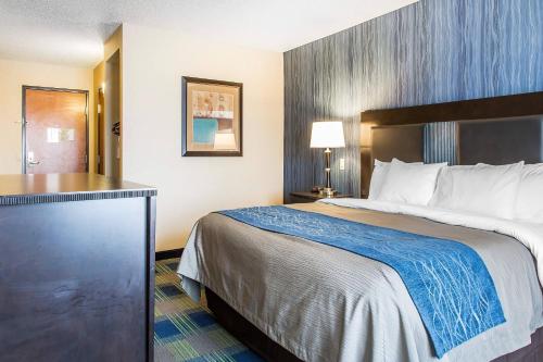 a hotel room with a bed and a desk at Comfort Inn & Suites Meriden East in Meriden
