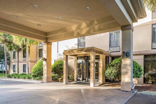 an entrance to a building with palm trees at Comfort Inn University in Gainesville