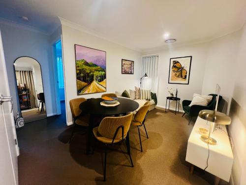 a living room with a table and a couch at The Baker's Bed - Private 2 King BR Guest Suite in Orange