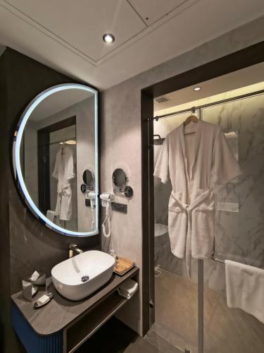a bathroom with a sink and a mirror at Sayaji Raipur in Raipur