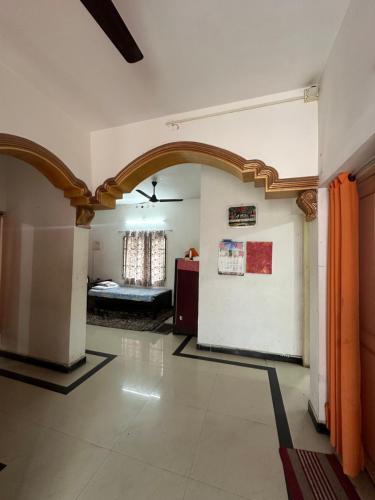 a living room with an archway and a bedroom at Hostel Honsa in Cochin