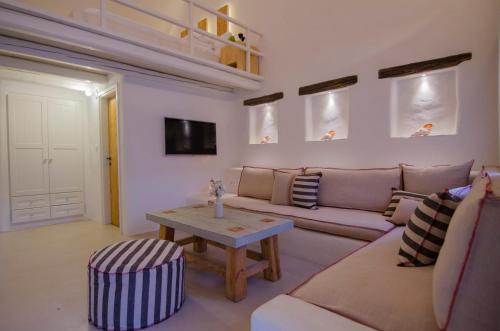 a living room with a couch and a table at Yialos Ios Hotel in Ios Chora
