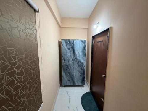 a hallway with a door in a room with a wall at G square The Premium Hotel in Rushikonda