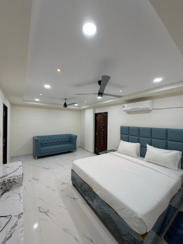 a bedroom with a large bed and a couch at G square The Premium Hotel in Rushikonda