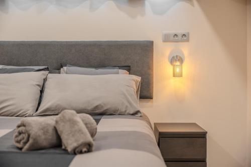 a stuffed animal on a bed in a bedroom at Playa Honda Design, Comfort & Pool in Playa de las Americas