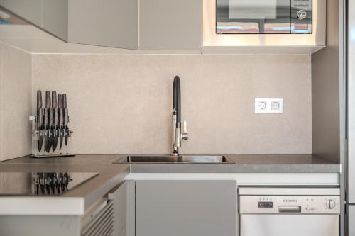 a kitchen with a sink and a counter top at Playa Honda Design, Comfort & Pool in Playa de las Americas