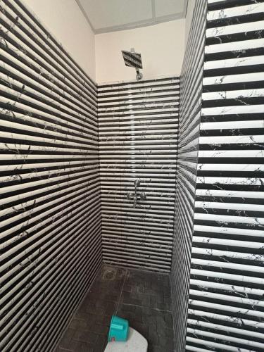 a bathroom with a shower with a toilet in it at Vansh Residency Couple Friendly Near Rajiv Chowk Gurgaon in Gurgaon