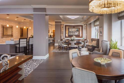 a dining room and living room with a table and chairs at Hyatt Regency Saint Louis at The Arch in Saint Louis