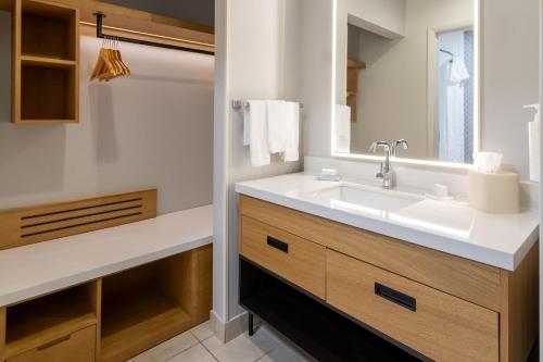 a bathroom with a sink and a mirror at Homewood Suites by Hilton Rochester/Greece, NY in Rochester