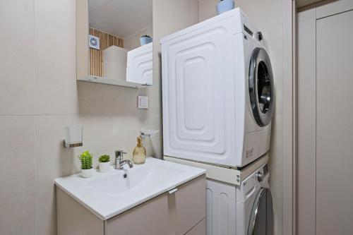 a kitchen with a sink and a washing machine at Prestige Center Warsaw Rooms Metro, AC, Smart TV, 2 Bathrooms in Warsaw