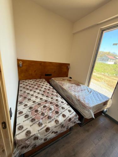 two beds in a small room with a window at Bakuriani in Bakuriani