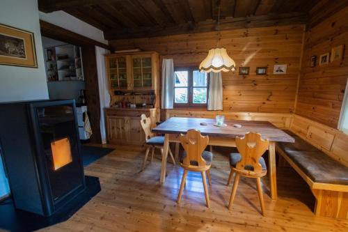 a dining room with a table and chairs in a cabin at Almhaus Falkertzeit in Koflach