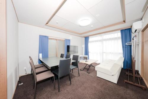 a dining room with a table and chairs at Otaru Canal Stay in Otaru