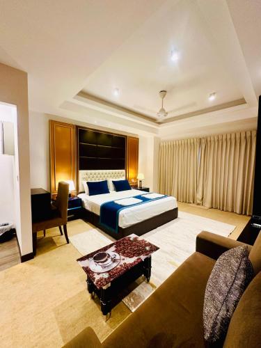 a hotel room with a bed and a couch at Sea view Serenity Negombo in Negombo