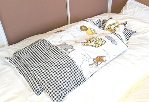 a bed with black and white pillows on it at 17min byCarTo Nagoya-Sta RoomB206 1parking Max5 Guest in Chiharachō
