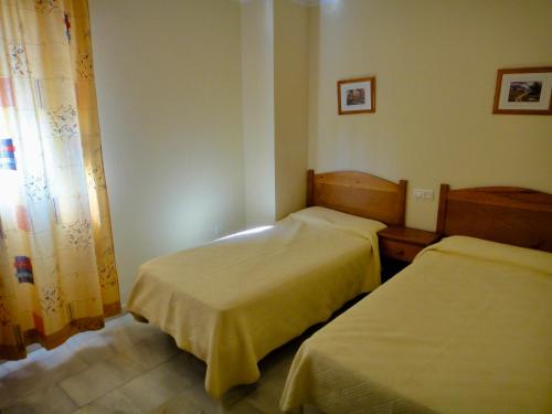 a bedroom with two beds and a window at Bertur San Antonio Mar in Alcossebre