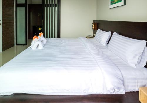 a large white bed with two stuffed animals on it at S2 Residence in Ao Nang Beach