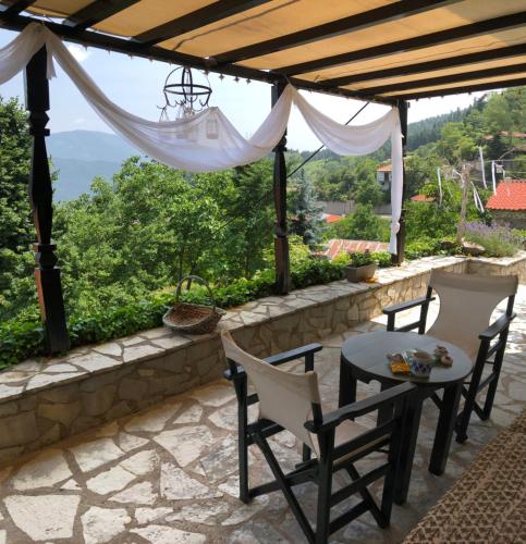a patio with a table and chairs and a view at ΤΟ ΑΡΧΟΝΤΙΚΟ in Kríkellon