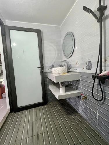 a bathroom with a mirror and a sink and a shower at Khách Sạn Long Dung in Nam Khê