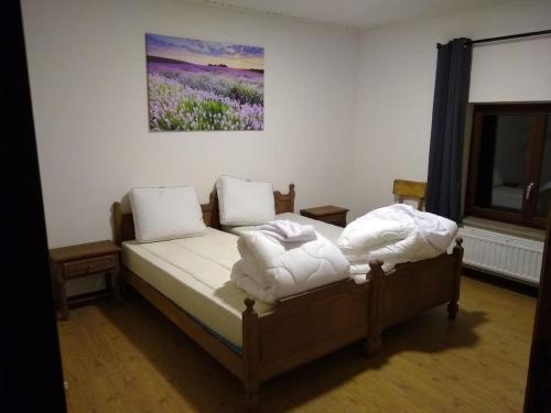 a bedroom with a bed with two pillows on it at Cosy farmhouse with sauna in Sint-Truiden