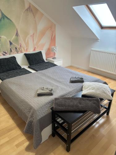 a bedroom with a large bed and a skylight at Sunrise 2 Apartment in Hajdúszoboszló