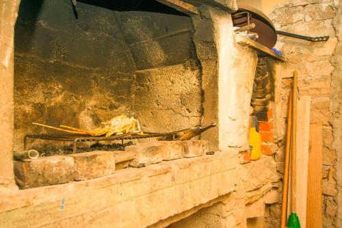 a brick oven with a fire inside of it at House Sarah in Tkon