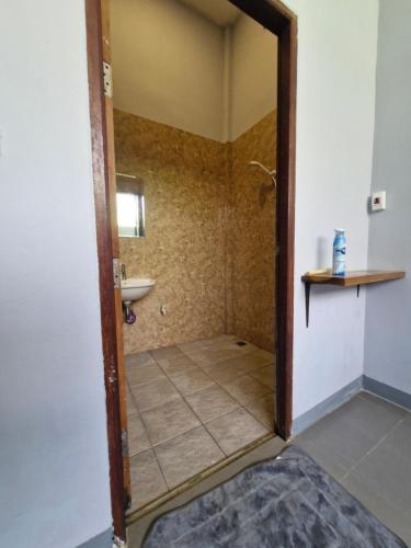 a bathroom with a shower and a sink at NaklangHillHouse in Ko Lanta Yai