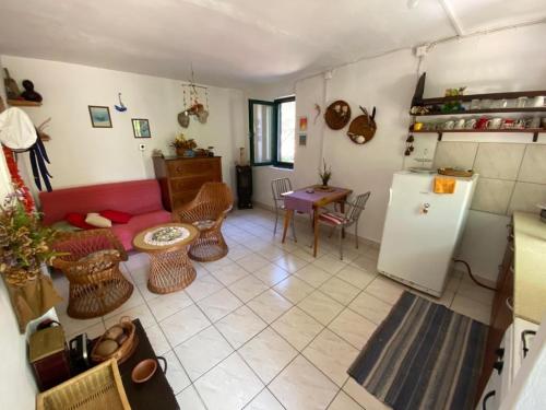 a living room with a red couch and a refrigerator at House Kornati Robinzon in Sit