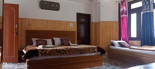 a bedroom with two beds in a room at Hotel Kailash View, Kalpa in Kalpa