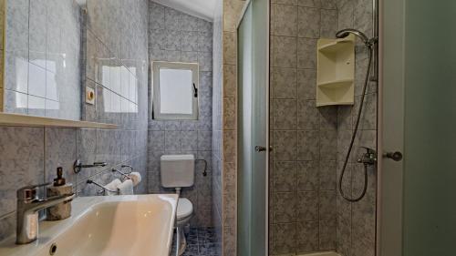 a bathroom with a sink and a shower at Villa Naty with Whirlpool by Villas Guide in Vela Luka