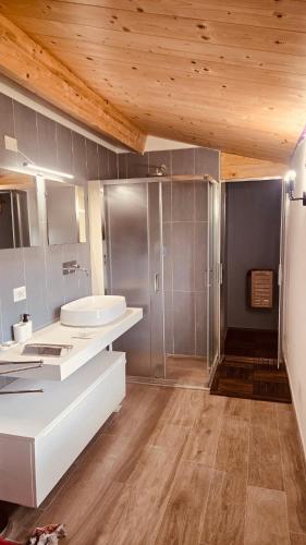 a bathroom with a white sink and a shower at La Traversa Di Bolsena in Bolsena