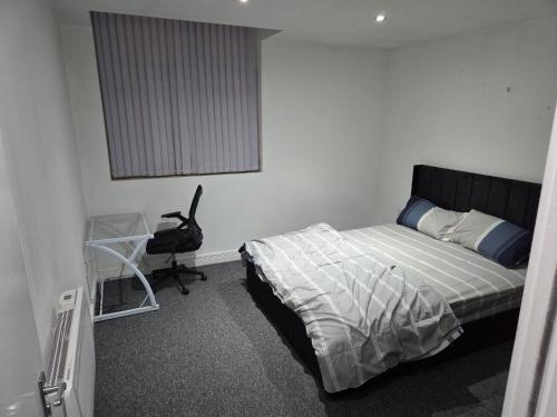a bedroom with a bed and a desk in it at Modern 1-Bed in Wolverhampton City Centre in Wolverhampton