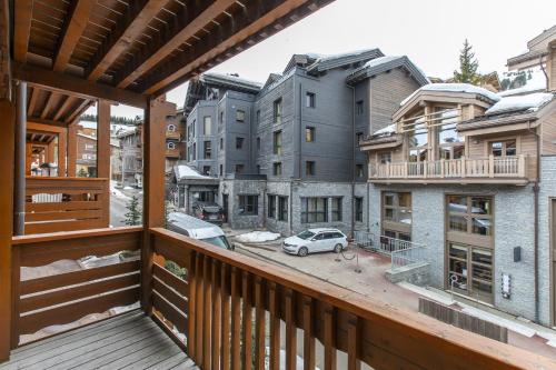 a balcony with a view of some buildings at Résidence Les Chalets du Forum - Courchevel 1850 in Courchevel