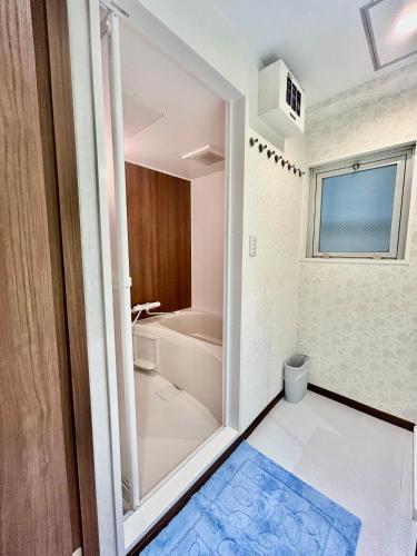 a bathroom with a shower and a toilet and a sink at Eko House in 横浜石川町駅 601室 in Yokohama