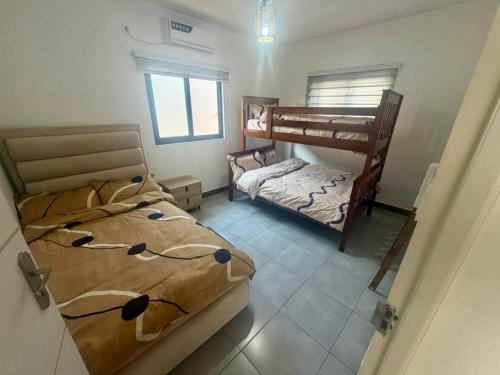 a bedroom with two bunk beds and a smaller bed at Ponta Rest House in Lopes
