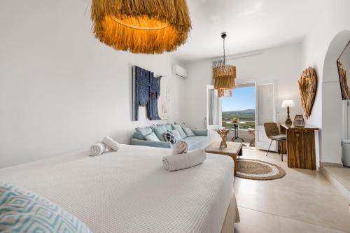 a bedroom with a bed and a living room at Casa View in Akrotiri