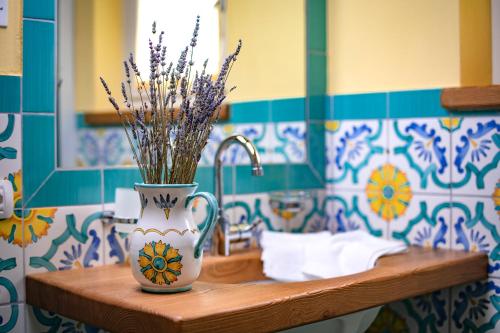 a vase with flowers in it on a table in a bathroom at Malga Zebari in Velo Veronese