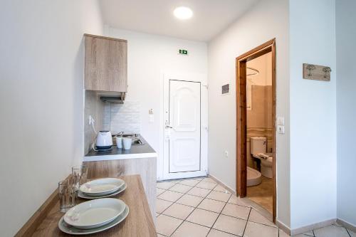 a kitchen with a table with plates on it at Olga Villa in Megali Ammos
