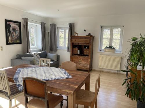 a living room with a table and a couch at Maisonette Giggi in Peiting