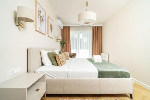 a white bedroom with a large bed and a window at Sand Boho Harmony Luxury - AC Parking & Balcony - by UniqueRent in Wrocław