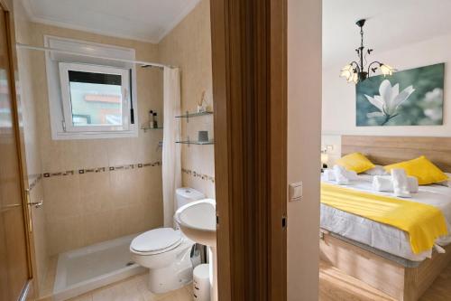 a bathroom with a bed and a toilet and a sink at Casa Vacacional El Alisu in Arriondas
