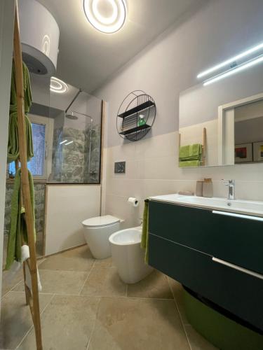 a bathroom with a toilet and a sink and a tub at Casa Danesi in Monteleone dʼOrvieto