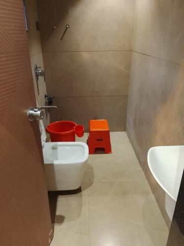 a small bathroom with a toilet and a sink at Hotel Gurudev Inn in Junnar